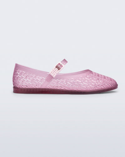 Side view of a clear pink Harper flat with strap