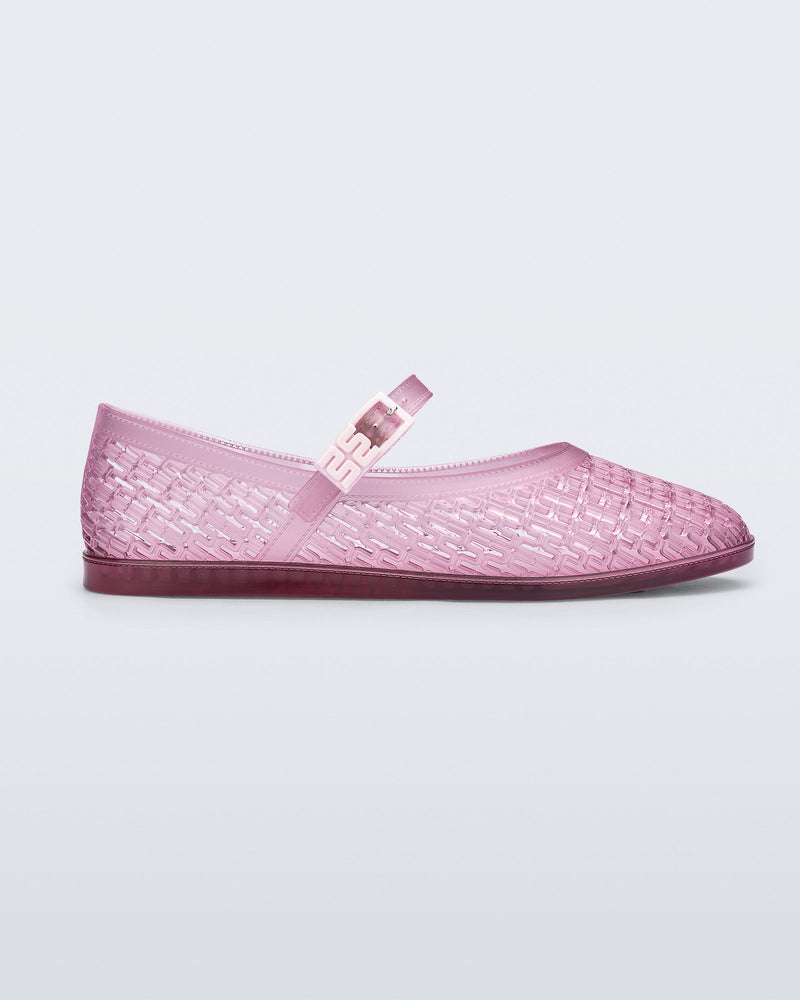 Side view of a clear pink Harper flat with strap