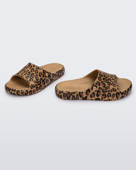 Angled view of a pair of beige Free Print Slides with leopard print