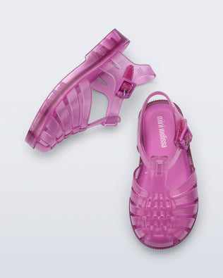 Top and side view of a pair of transparent pink Possession fisherman baby sandals