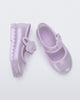 Side and top view of a pair of pearly lilac Hip Ballerina baby flats with strap with flower