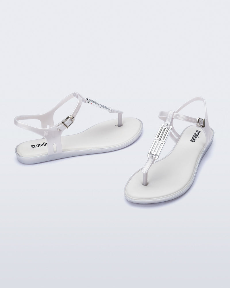 Side and front view of a pair of pearly white Solar M Chic sandals