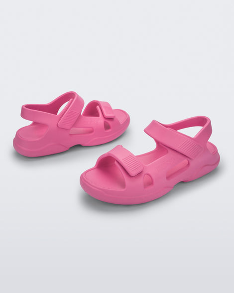 Angled view of a pair of pink Free Papete sandals