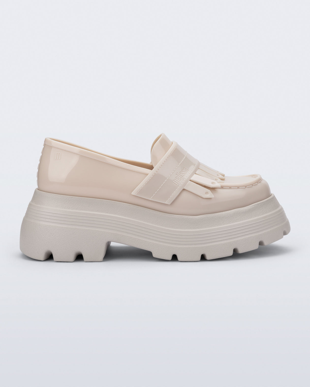 Side view of a beige Royal Plus platform loafer