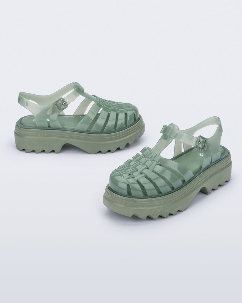 Side and angled view of a pair of green Possession Platform II sandals.