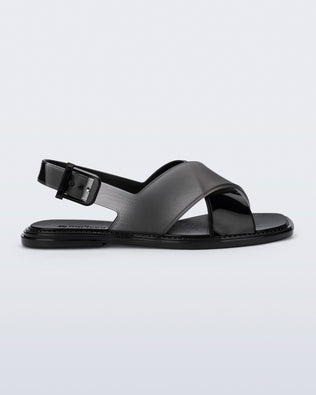 Side view of a black Cleo sandal with back strap and crisscross top straps