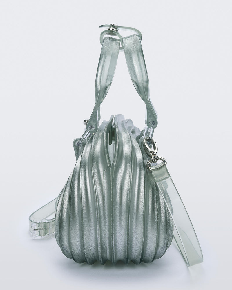 Side view of a transparent blue Quantum Dome + Diesel bag with hand strap and shoulder strap