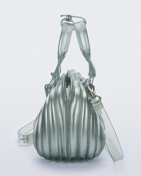 Side view of a transparent blue Quantum Dome + Diesel bag with hand strap and shoulder strap