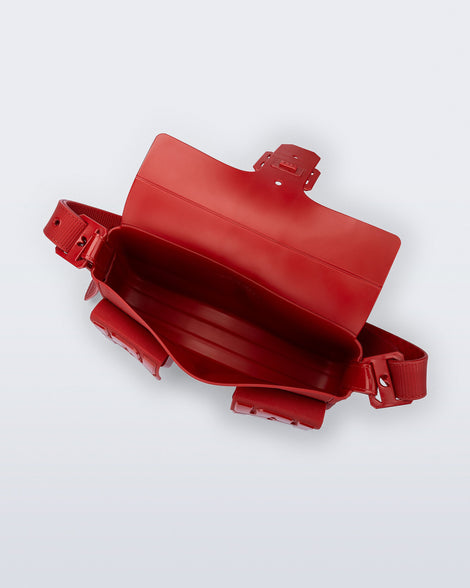 Top view of a red Cargo bag with two small pockets on the front and an adjustable strap