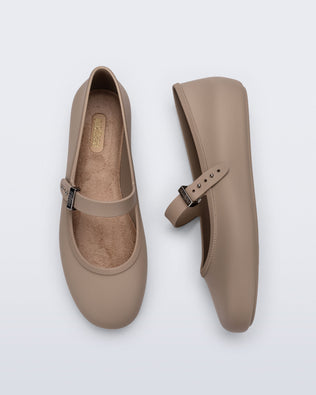 Side and top view of a pair of dark beige Soft Ballerina flats with top buckle strap