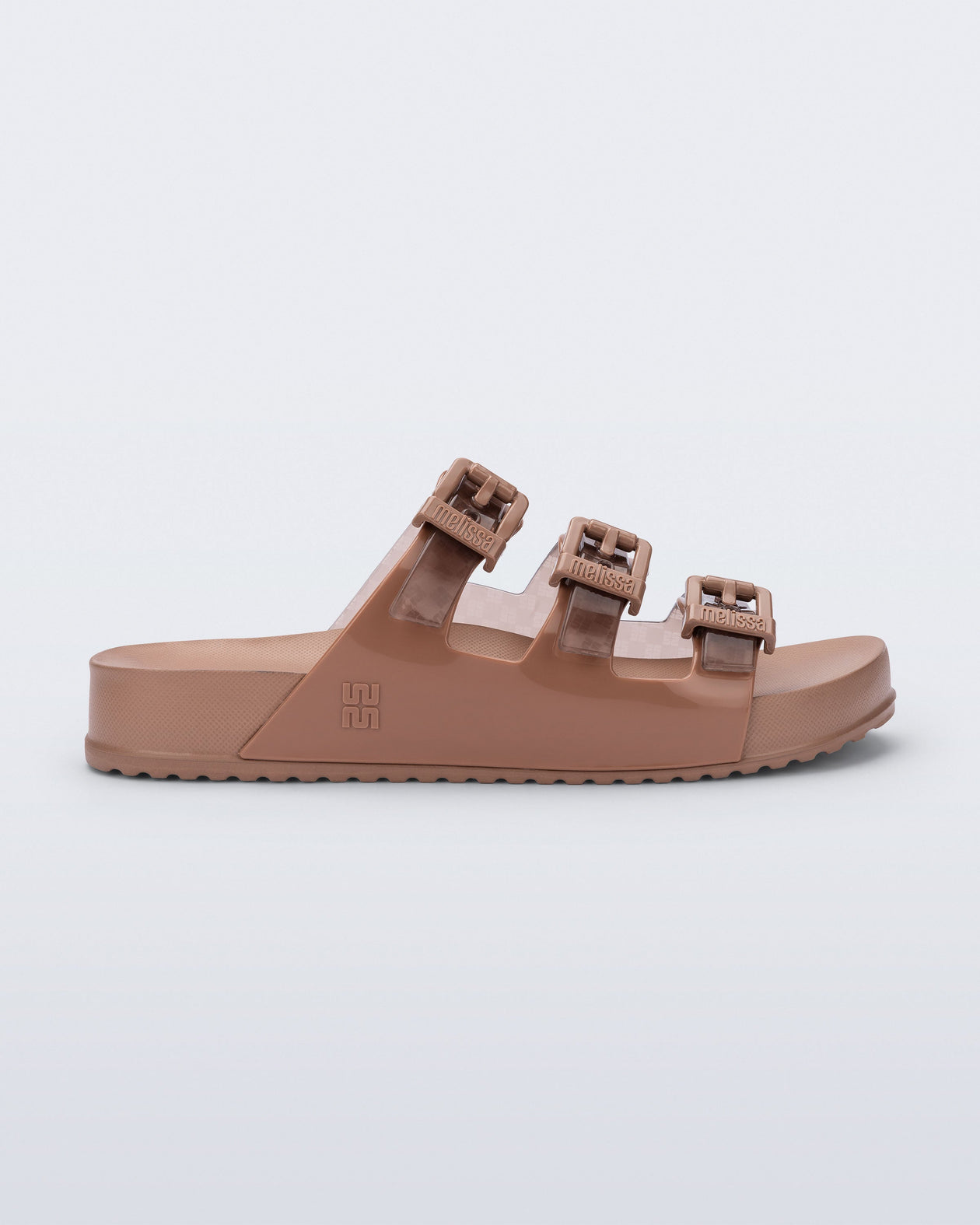 Side view of a brown Cozy Stripes sandal with transparent brown upper with 3 buckles