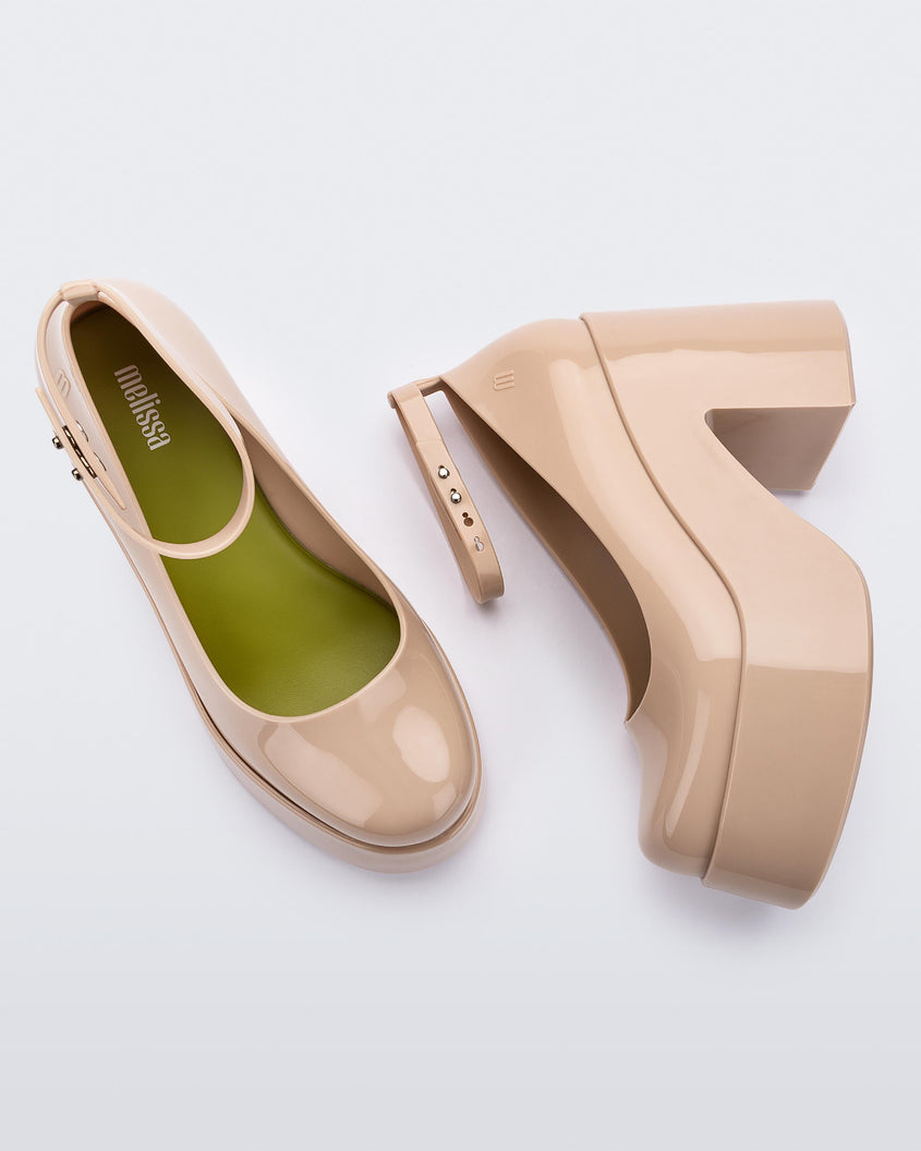 Top and side view of a pair of beige Melissa Doll Heel platforms with ankle strap and green insole.