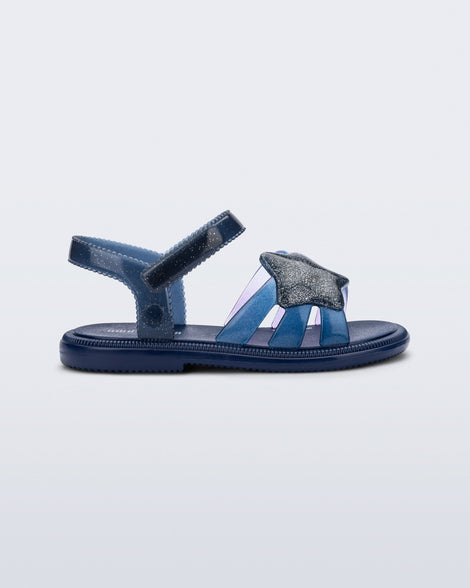 Side view of a glitter blue Hip Sky baby sandal with a glitter blue star on top