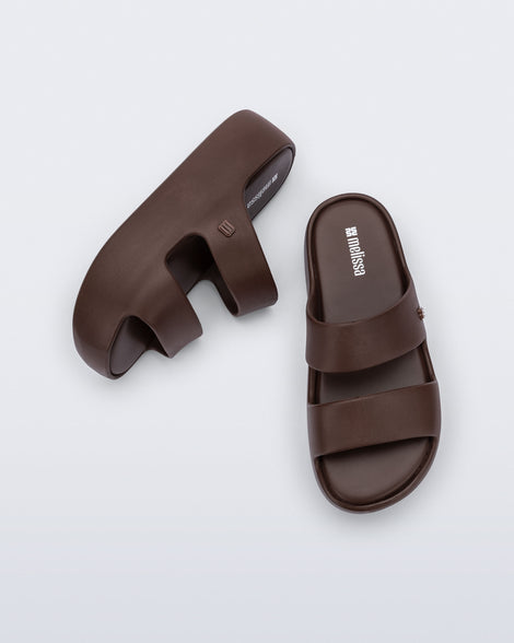 Top and side view of a pair of brown Free Line Platform slides