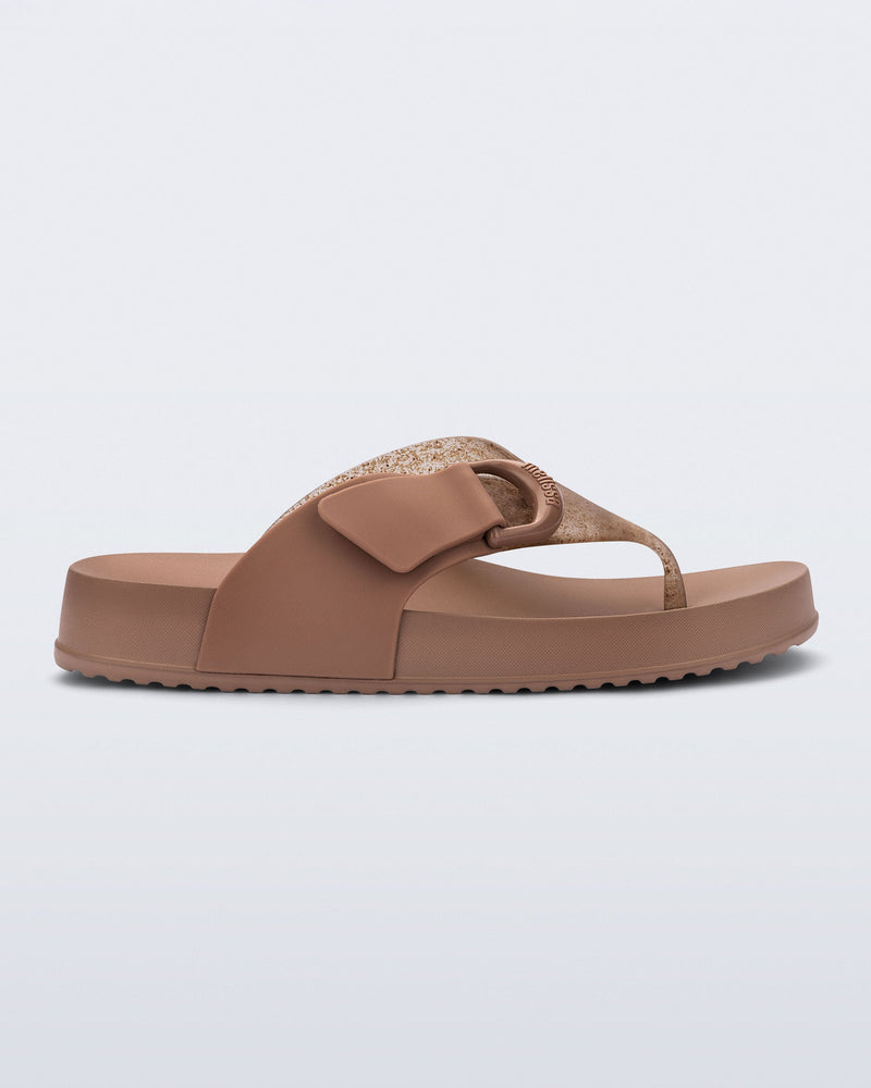 Side view of a brown Cozy Thong flip flop