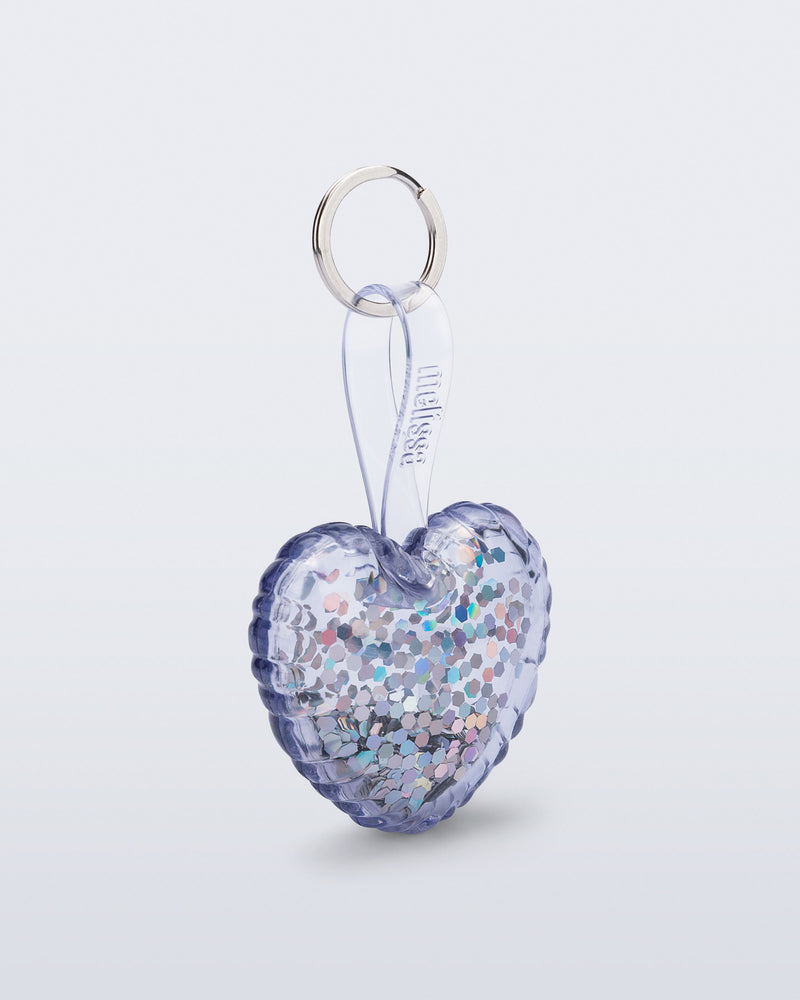 Angled view of a clear with glitter Heart bag charm