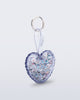 Angled view of a clear with glitter Heart bag charm