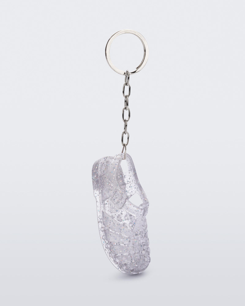 Side angled view of glitter clear Possession keyring