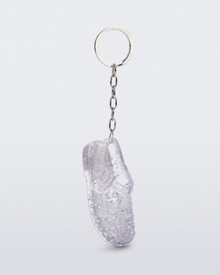Side angled view of glitter clear Possession keyring