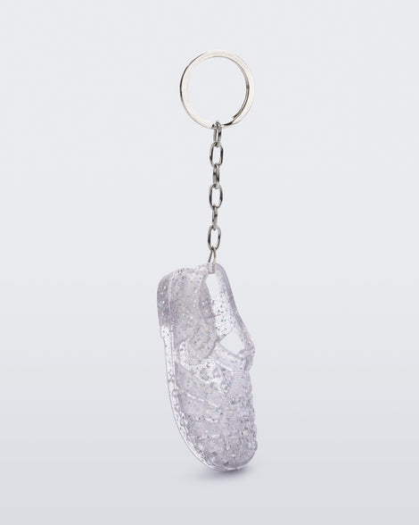 Side angled view of glitter clear Possession keyring