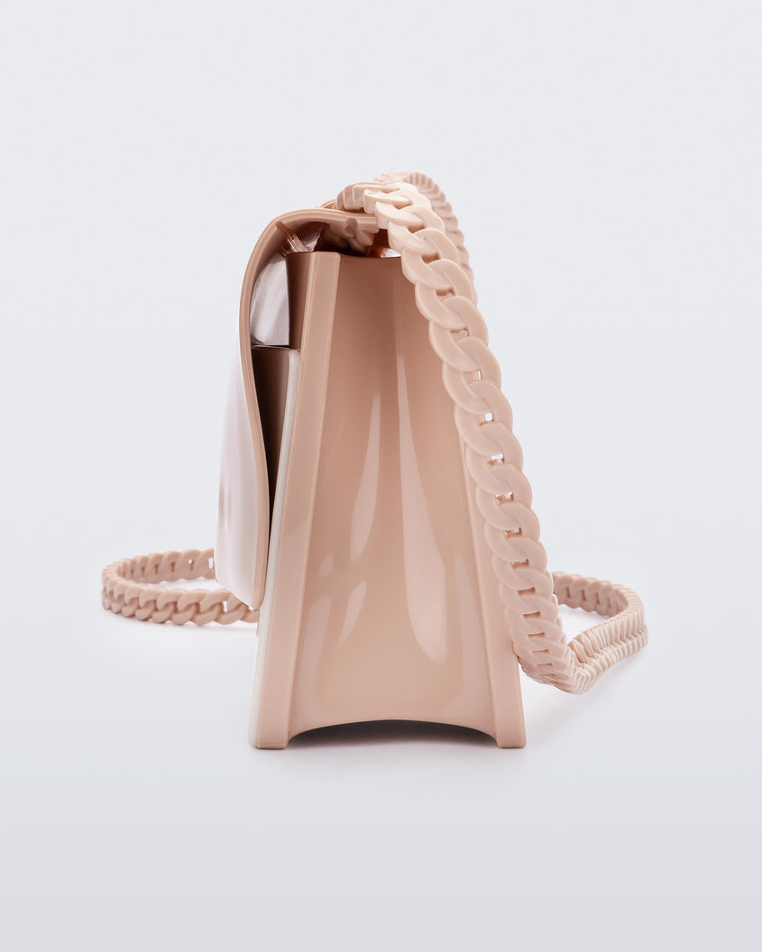 Side view of the Melissa party handbag in beige with braided strap.