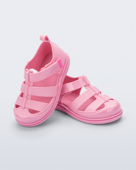 Angled view of a pair of pink Smash closed toe baby sandals