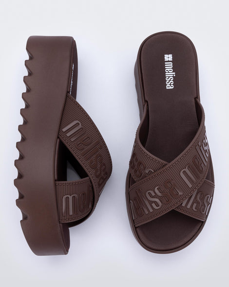 Top and side view of a pair of brown M Lover Cross Strap platform slides
