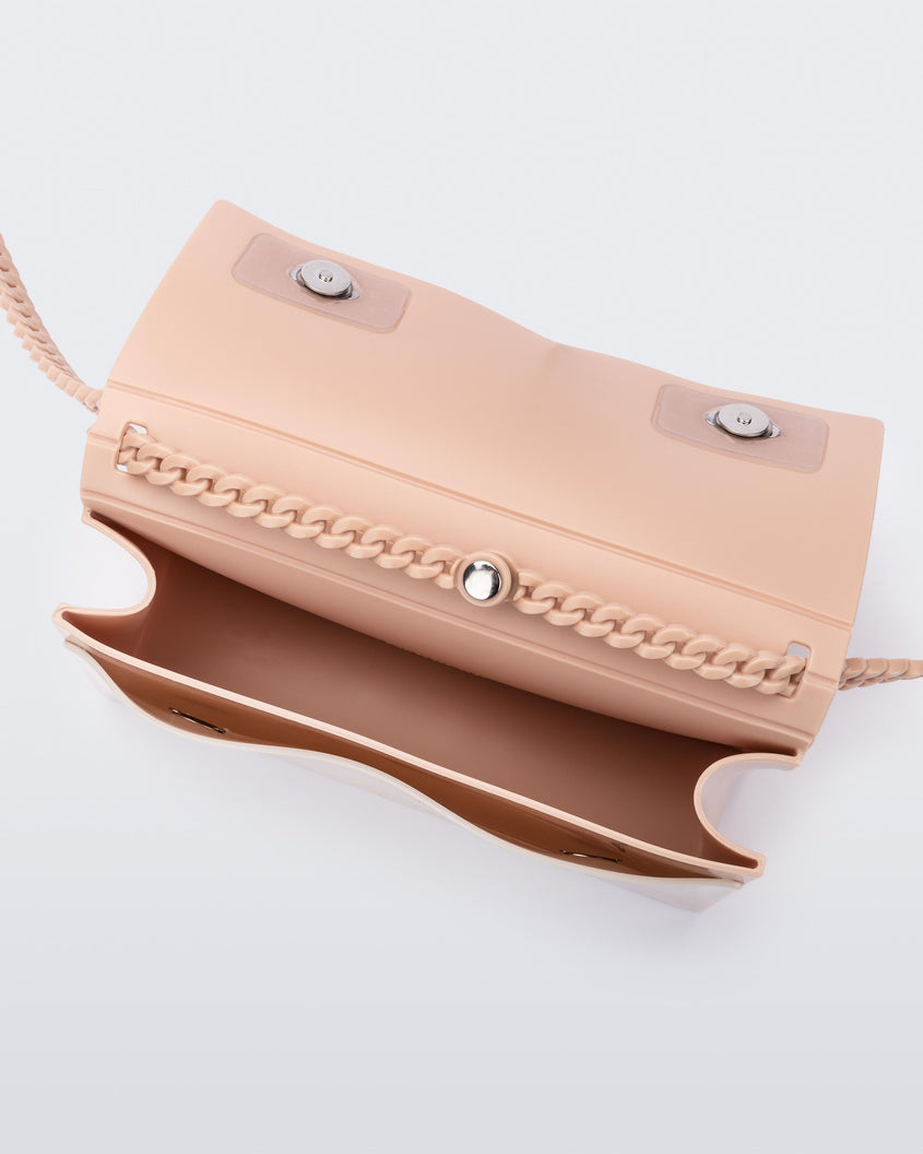 Inside view of the Melissa party handbag in beige with main interior pocket and front small pocket