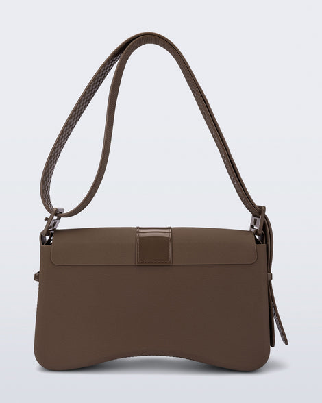 Back view of a brown Cargo bag with two small pockets on the front and an adjustable strap