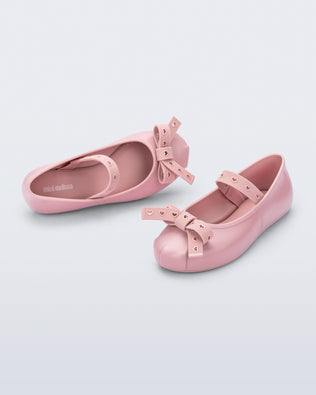 Top and angled view of a pair of pink Sophie Crush kids ballerina flats with bow