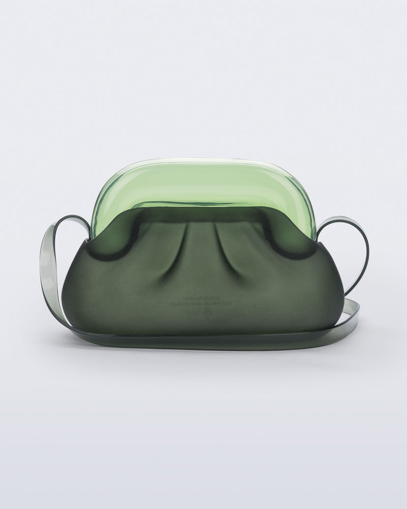 Back view of a small green bag with clear green clutch and long strap