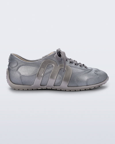 Side view of a silver Motion sneaker with grey laces