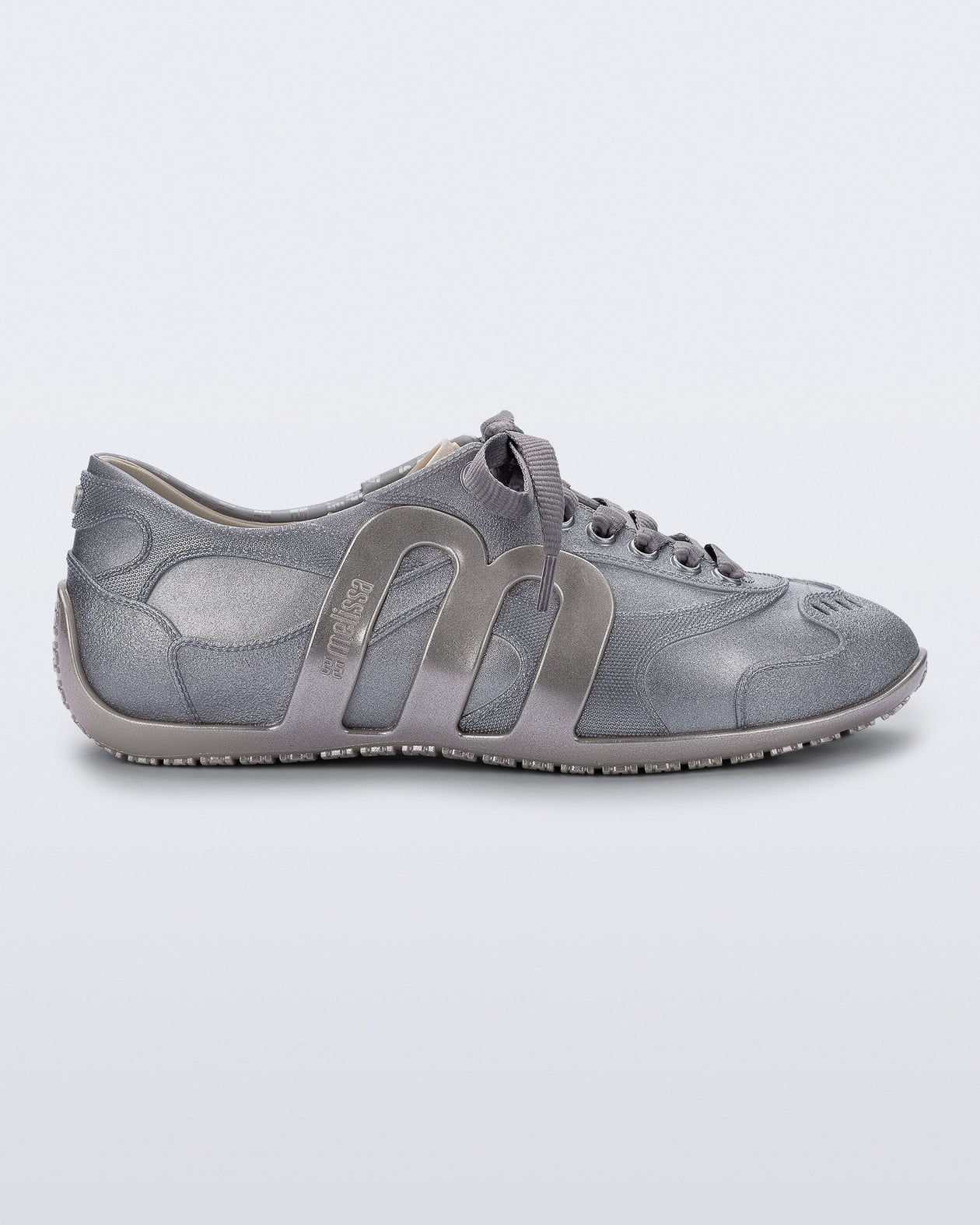 Side view of a silver Motion sneaker with grey laces