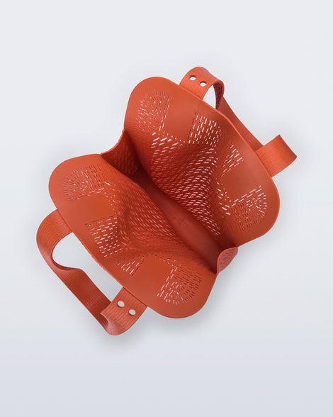 Top view of an orange Harper bag with shoulder straps