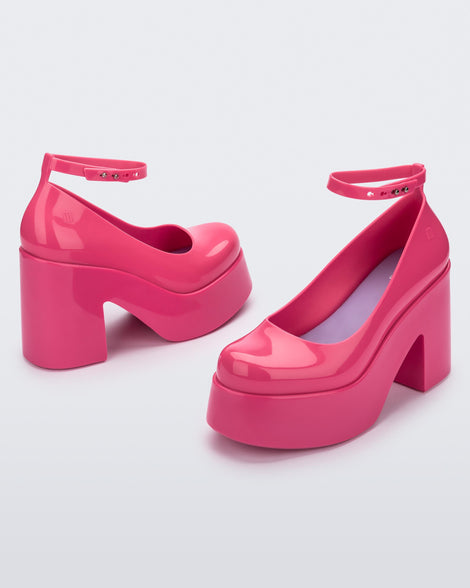 Angled view of a pair of pink Doll Heel women's platform shoes.