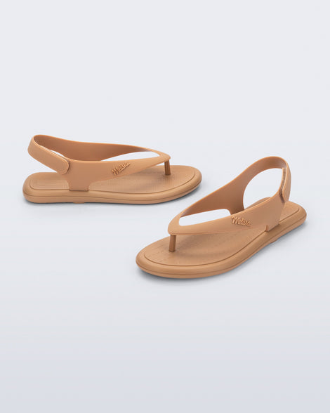 Side and angled view of a pair of dark beige Sun Samba thong sandals