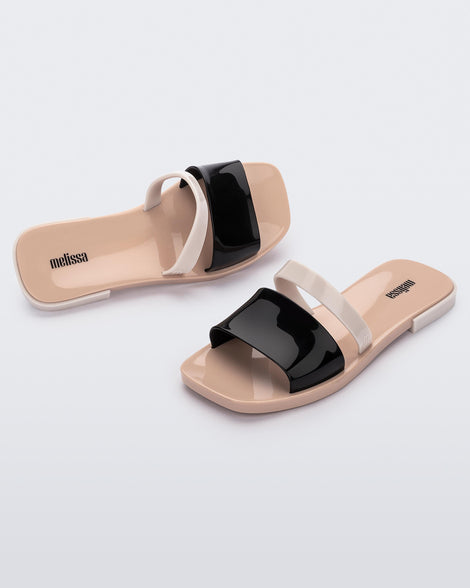 Top and angled view of a pair of black and beige Ivy women's slide
