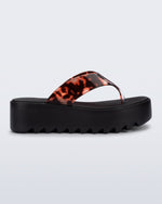 Side view of a black Thong Platform flip flop with tortoise colored strap