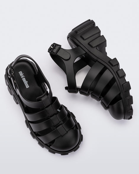 Side and top view of a pair of black Megan kids heel sandals.