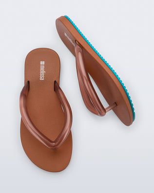 Top and side view a pair of brown Flip Flop Airflow sandal with a clear brown strap and blue bottom
