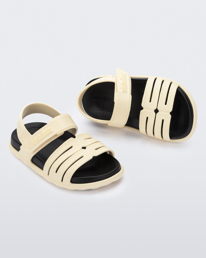 Top and angled view of a pair of beige with black insole Kaiteki baby sandals