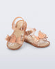 Angled view of a pair of glitter beige baby Butterfly sandals with beige butterflies