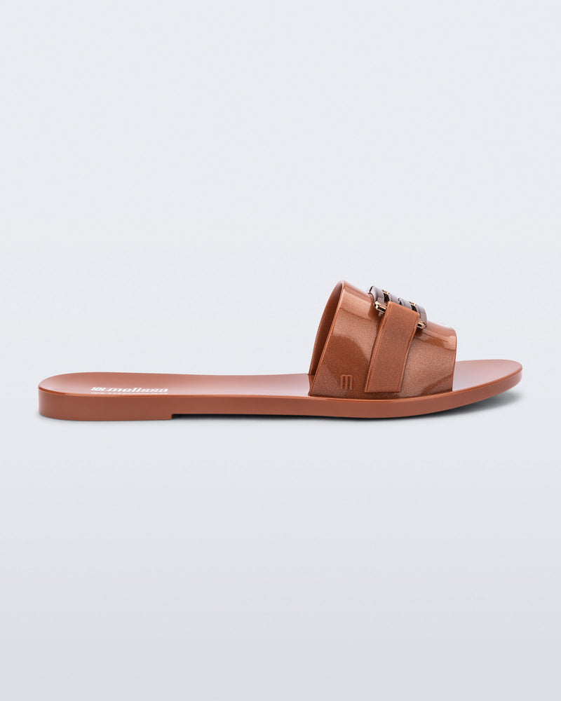 Side view of a brown Babe M Chic slide sandal.