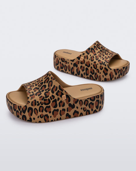 Angled view of a pair of beige Free Print Platform slides with a brown and black leopard print.