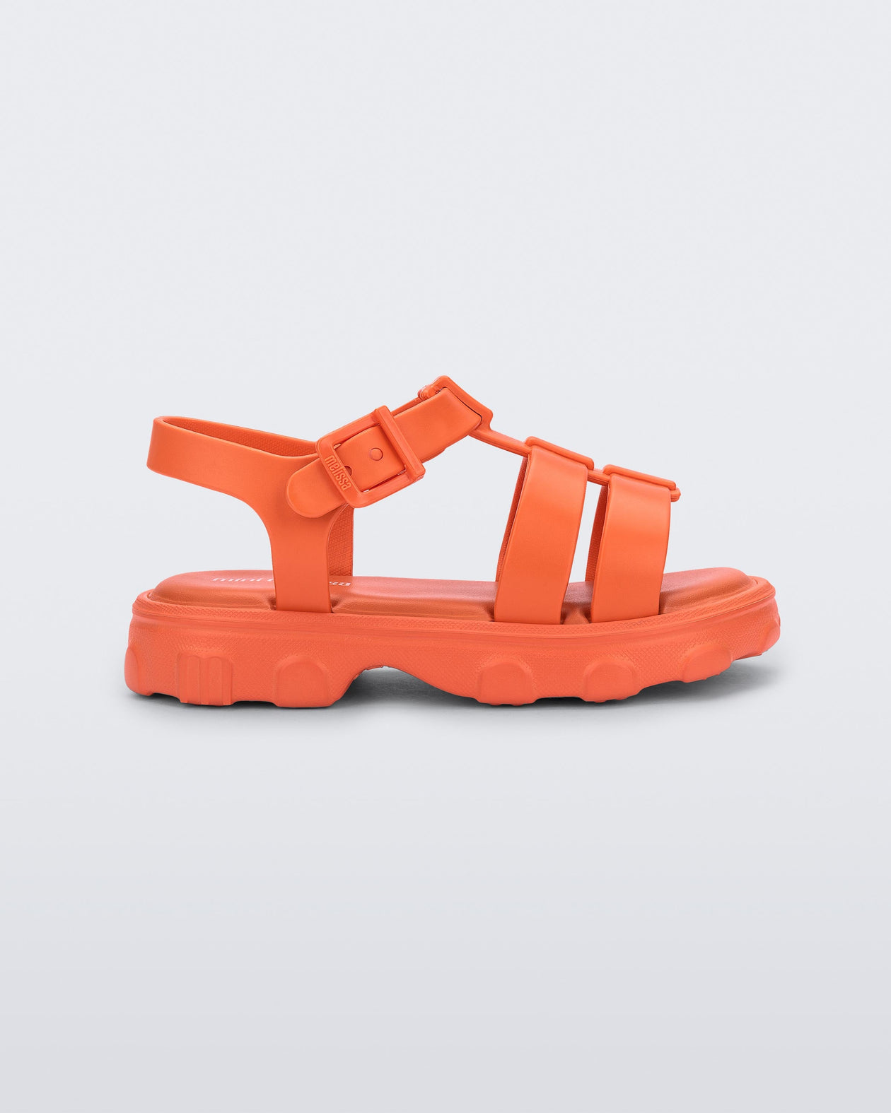 Side view of an orange Ella sandal with ankle strap
