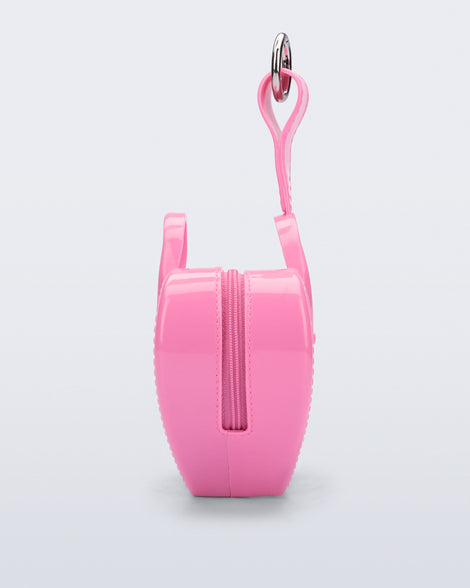 Side view of a pink Heartbeat Pocket bag charm