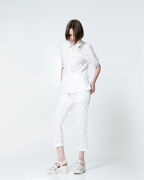 Model in a white outfit wearing a pair of beige Lulu platform heel fisherman sandals