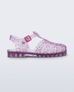 Side view of a clear Possession kids sandal with pink heart glitter