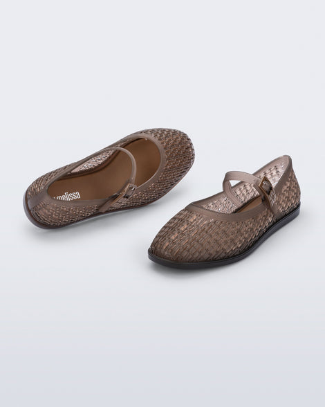 Top and angled view of a pair of transparent brown Harper flats