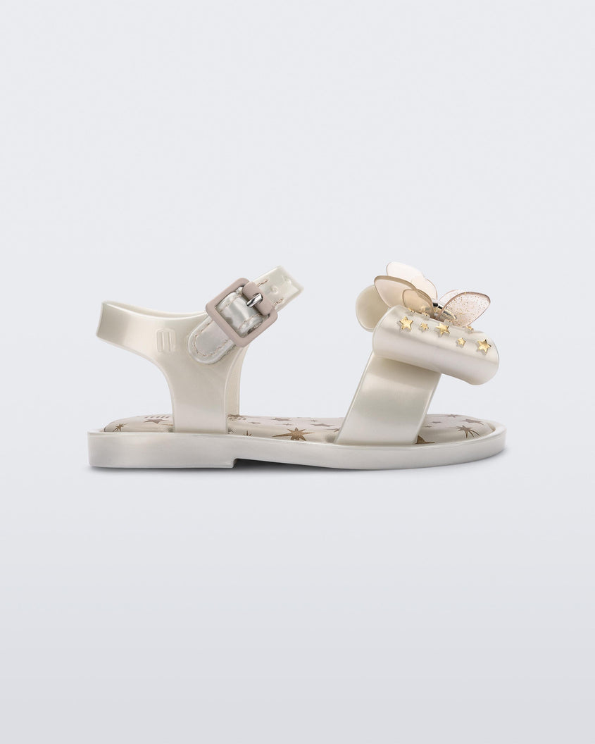 Side view of the Mini Melissa Mar Sandal with star print for baby in white with butterfly bow applique and velcro closure on ankle strap.